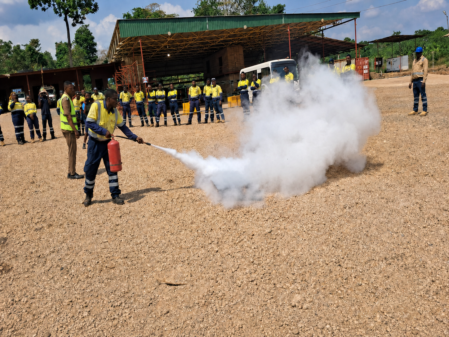 GTS employees observing a fire-extinguisher safety training demonstration
